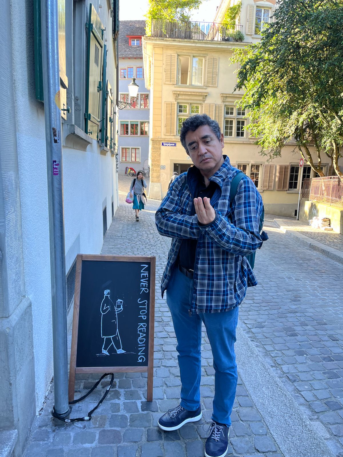 Francisco Rodríguez-Henríquez beside a Never Stop Reading sign